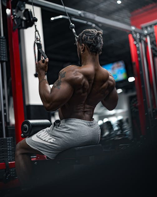 Shirtless man alone in gym